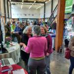 Islanders mingle in Vashon High School&rsquo;s atrium during Sunday&rsquo;s Earth Day Celebration. (Kevin Jones Photo)