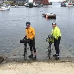 Islanders Bob Horsley (left) and Bruce Morser (right) dip their tires in the Atlantic Ocean Monday before heading on their two-month-long cross-country ride back to Vashon. (Courtesy Photo)