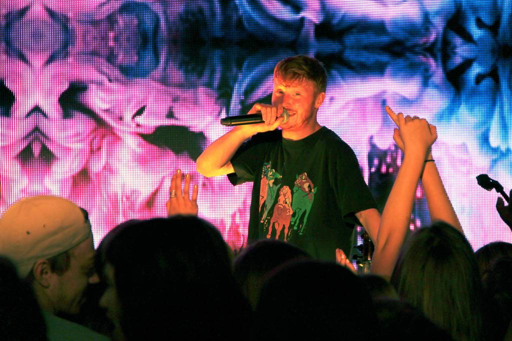 Musical artist Manatee Commune looks out at the audience of high school students Friday morning. (Anneli Fogt/Staff Photo)