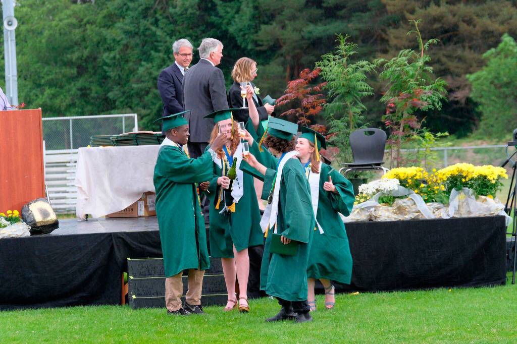A group of VHS students, including Eva Anderson, Issac Hughes and Eleanor Hughes, toast graduation with apple cider after receiving their diplomas Saturday. (Kent Phelan Photo)