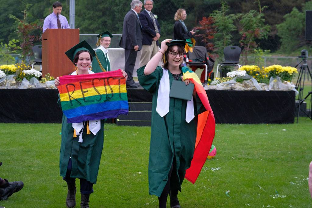 Graduating VHS seniors walk away from the stage Saturday with rainbow Pride flags. (Kent Phelan Photo)