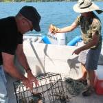 John Cushing and Lynn Miller examine their catch. (Susan Riemer/Staff Photo)