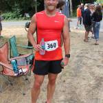 Aaron Burby, son of Bill, after his win in the 10k last Saturday. (Susan Riemer/Staff Photo)