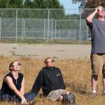 A trio wearing eclipse glasses marvels at Monday&rsquo;s partial eclipse from Vashon&rsquo;s Sunrise Ridge. (Anneli Fogt/Staff Photo)
