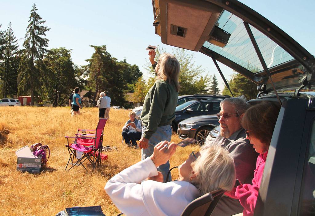 Temperatures dropped slightly on Monday as the moon obscured 92 percent of the sun and islanders took to Sunrise Ridge and other places on the island to view the spectacle. (Anneli Fogt/Staff Photo)