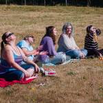 A group of women smiles and laughs as the eclipse occurs Monday morning. (Kent Phelan Photo)