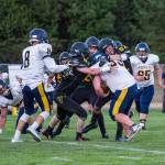 VHS players left to right: Junior Jess Leysath, junior Will Hennessey and senior Stephen Rice attempt to bring down a Forks player during Friday&rsquo;s game at the VHS stadium. (Kent Phelan Photo)
