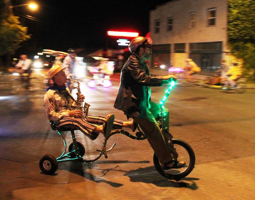 A man playing a saxophone hitches a ride with a &ldquo;stupid biker.&rdquo; (Susan Riemer/Staff Photo)