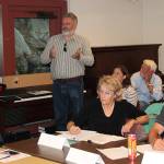 At last week&rsquo;s meeting of the Triangle Route Improvement Task Force, William Shadbolt, standing, discusses the need for a larger dock, while WSF&rsquo;s Greg Faust and task force member Margaret Clements, seated at the table, listen. (Susan Riemer/Staff Photo)