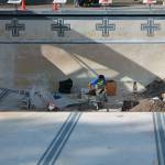 A construction worker moves among piles of dirt at the bottom of the Vashon Pool as he works on fixing the main drain, which was found to be out of compliance with a 2007 law requiring anti-entrapment drain covers and other safety devices on pool and spa drains. (Anneli Fogt/Staff Photo)