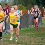 Pirates Ella Yarkin and team captain Lucy Boyle (in yellow) race along the barriers during the Hole in the Wall Invitational in Lakewood. Both girls went on to set records on the 5-kilometer course: Yarkin finished with a personal best time of 21:29, and Boyle finished with a season-best time of 21:41. (Jeff Johnston Photo)