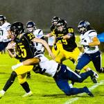 Vashon High School junior quarterback Grady Earle (#25) is taken down by Cascade senior defensive lineman Jeremy Ocbian during last Friday&rsquo;s game. (Kent Phelan Photo)