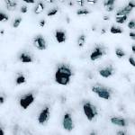 Snow fills in the spaces between openings on an outdoor table. (Karen Fuller Photo)