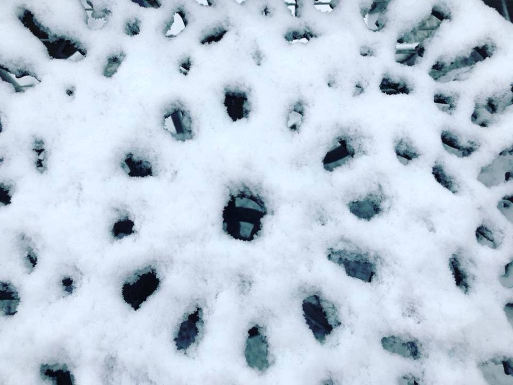 Snow fills in the spaces between openings on an outdoor table. (Karen Fuller Photo)
