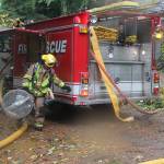 With the passage of the fire districts levy, VIFR is working to hire more firefighters, both full and part time. Above, volunteer firefighter Mike Kirk assists at last weeks house fire. (Susan Riemer/Staff Photo)
