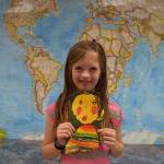 Chautauqua student Maude Jackson with the self portrait art she will send to a Mexican childrens shelter with Staff member Sally Adam later this week. (Courtesy photo)