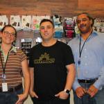 Euphorium co-owner Ben Bentitou, center, and two employees pause for a photo while stocking the shelves on the stores opening day. (Sarah Low/Staff Photo)