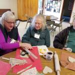 A volunteer leads a Valentines cookie-making session at Vashon Elder Care. (Courtesy Photo)