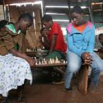 Phiona Mutesi, right, plays chess as a young girl in Uganda. (Courtesy Photo)