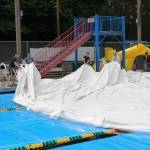 <strong></strong>Nearly 30 volunteers gathered to take the dome down at the pool on Sunday. (Susan Riemer Photo)