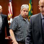 Tony Reed (center) leaves the courtroom during a jury break, glancing toward the seating area for the families of victims Monique Patenaude and Patrick Shunn. (Dan Bates / The Herald)