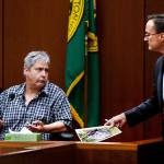 After showing Tony Reed (left) an evidence photo Tuesday, Snohomish County chief deputy prosecutor Craig Matheson listens as Reed testifies. (Dan Bates / The Herald)