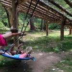 The children at Isabelles Playschool enjoy the saucer swing located under one of the climbing structures built with logs from the property. (Isabelle Porter Photo)