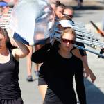 Mabel Moses, left, and Olivia White on their way to the water, and their win, in the open womens eight event at the Green Lake Summer Extravaganza regatta on Saturday. (Lenny Kong Photo)