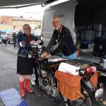 Nancy and Chris OBrien tend to Chris vintage motorcycle under the awning of their van.                                Courtesy Photo                                Nancy and Chris OBrien tend to Chris motorcycle under the awning of their van (Courtesy Photo).