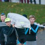 Vashons Junior quad carries their boat, Passport 2 Pain, to the water, ahead of their gold medal row at American Lake. This is the lineup thats headed to Boston this week to row at Head of the Charles. From left to right: Rohin Petram, Oz Hichens, Tor Ormseth (hidden behind the boat) and Bowie Hichens (Jordan Petram photo).