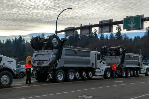 Trucks in line to take millings off island last Thursday. (Susan Riemer/Staff Photo)