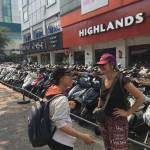 Andrea Walker talks with a local Hanoi resident in front of the ubiquitous scooters. (Scott Durkee)