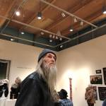 Ron Hook, a stalwart of Vashons art and music scene, checks out a recent fiber arts exhibition at VCAs Koch Gallery (Tom Hughes Photo).