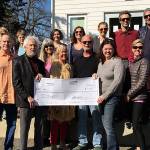 Members of the cast and crew celebrate their success and deliver earnings from their efforts to DOVE Project principals Heidi Jackson, Tracy McLaren and Kyle Britz (Courtesy Photo).