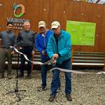 Gib Dammann, president of Zero Waste Vashon, cuts the ribbon on a new anaerobic digester unveiled Tuesday at the Island Spring Organics tofu factory. From left, those gathered include Srirup Kumar and Jan Allen of Impact Bioenergy and Steve Bergman, also of Zero Waste Vashon (Susan McCabe Photo).