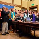 Gov. Jay Inslee signs one of five orca recovery bills on Wednesday that protect the safety and livelihood of the Southern Resident orca (Office of the Governor photo).