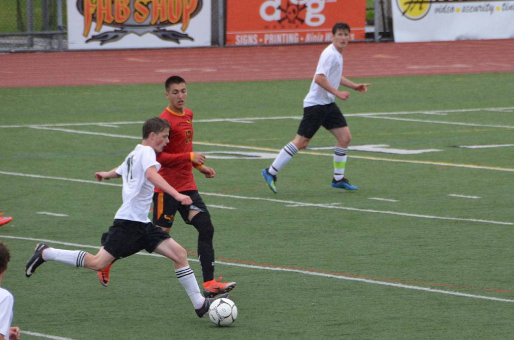 Jacob Heuschert controls the ball on the field with United in the championship game, while Tommy Delargy looks on. (Jim Westcott Photo)