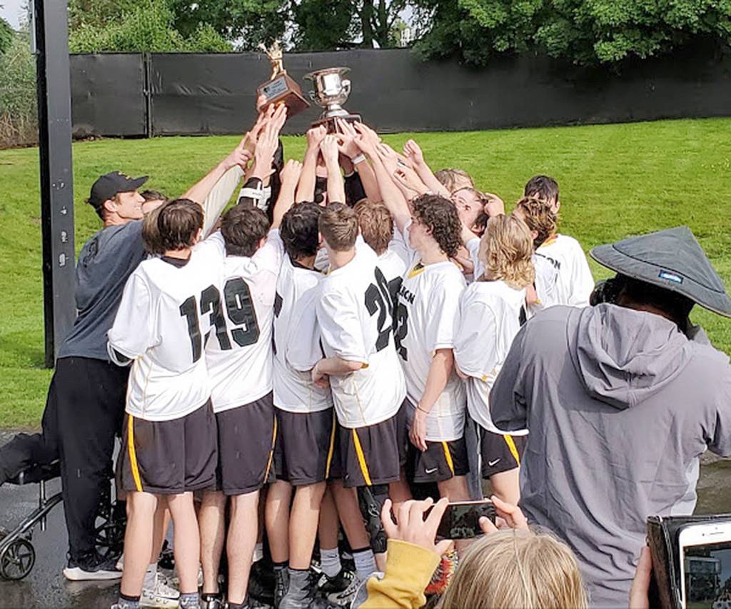 Team members celebrate their win after the game. (Robert Mazur Photo)