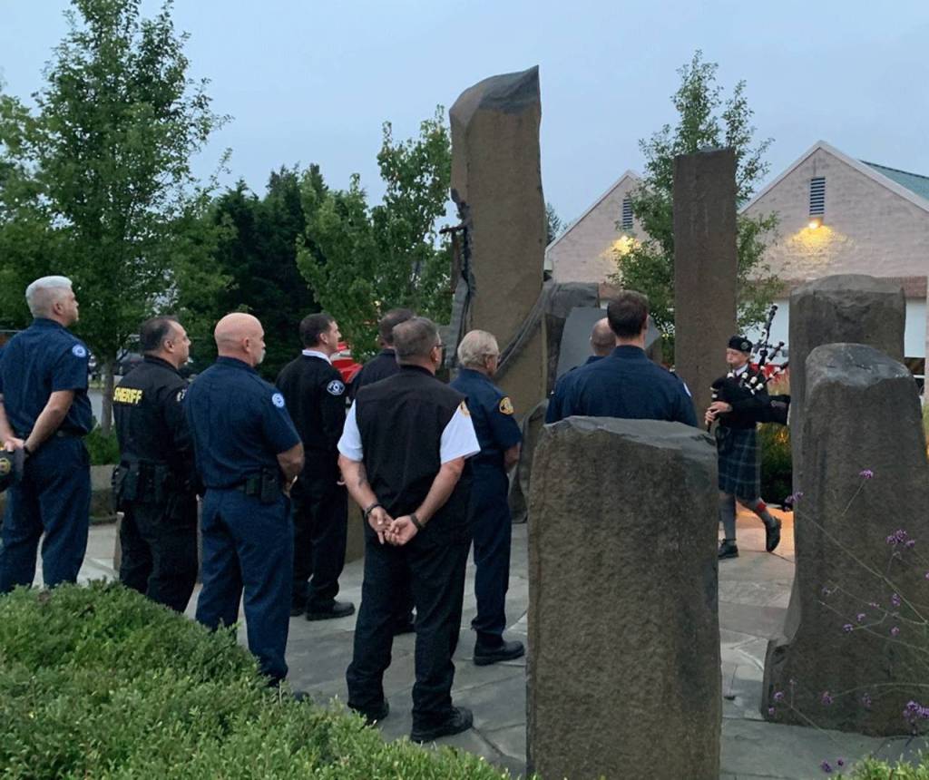 Sixteen year old Ella Yarkin plays the bagpipes at dawn at dawn on Sept. 11 at the Vashon fire station to pay tribute to the victims of the 2001 terrorist attacks. (Kevin Opsahl/staff photo)