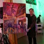 Steffon Moody poses with his top-selling painting, created on the spot during Vashon Center for the Arts annual art auction (Courtesy Photo).