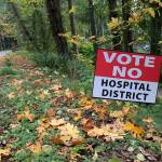 A sign urging islanders to vote against the proposed public hospital district is seen along Vashon Highway on Friday, Oct. 25 (Kevin Opsahl/Staff Photo).