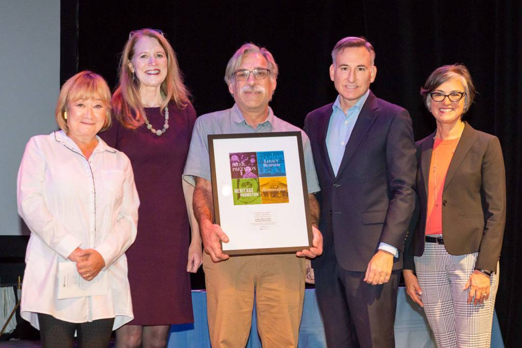 Vashon Heritage Museum officials Rota Brogan, Elsa Croonquist and Brian Brenno stand with King County Executive Dow Constantine and Jennifer Meisner, a historic preservation officer, during a ceremony to accept the Spellman Award for two of the museums exhibits (Courtesy Photo).