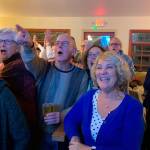 Eric Pryne, left, reacts to election results with LeeAnn Brown, right, at the Vashon Brewing Community Pub on Tuesday, Nov. 5 (Kevin Opsahl/Staff Photo).