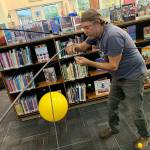 Scott Durkee with the mobile he created for the McMurray Middle School library (Kevin Opsahl/Staff Photo).