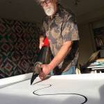 Jim Woodring uses his giant pen tool to draw a picture at his home (Andy James Photo).
