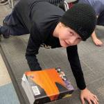 Chautauqua Elementary School student Jude Dardeau did a single arm weighted plank holding a heavy book in one hand. (Lisa MacLeod Photo)