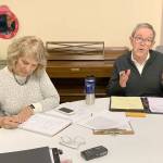 Tom Langland, president of the Vashon Health Care District Board of Commissioners, speaks to members of the public after the boards meeting at the Vashon Presbyterian Church on Thursday, Jan. 2. Commissioner LeeAnn Brown is seated to his right (Kevin Opsahl/Staff Photo).