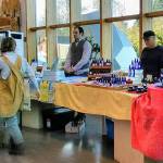 Shoppers walk through the VIGA winter farmers market in the Vashon Center for the Arts lobby (Paul Rowley/Staff Photo).