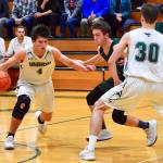 Jeremiah JJ Bogaard, senior guard, dribbling the basketball, as his teammate, senior forward Isaac Patchen (jersey No. 30) looks on (Pam Stenerson Photo).