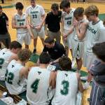 Coach Andy Sears, assistant coaches and the Vashon High School boys basketball team huddle during a game. (Doug Langworthy / Photo)